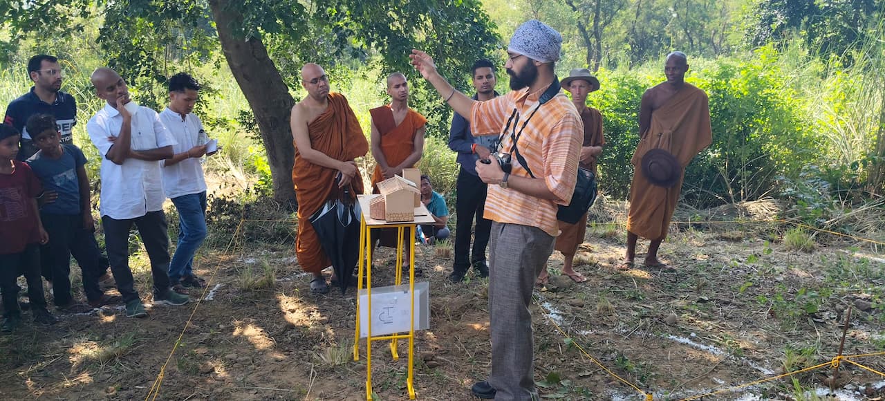 Architect interacting with the monks outdoors